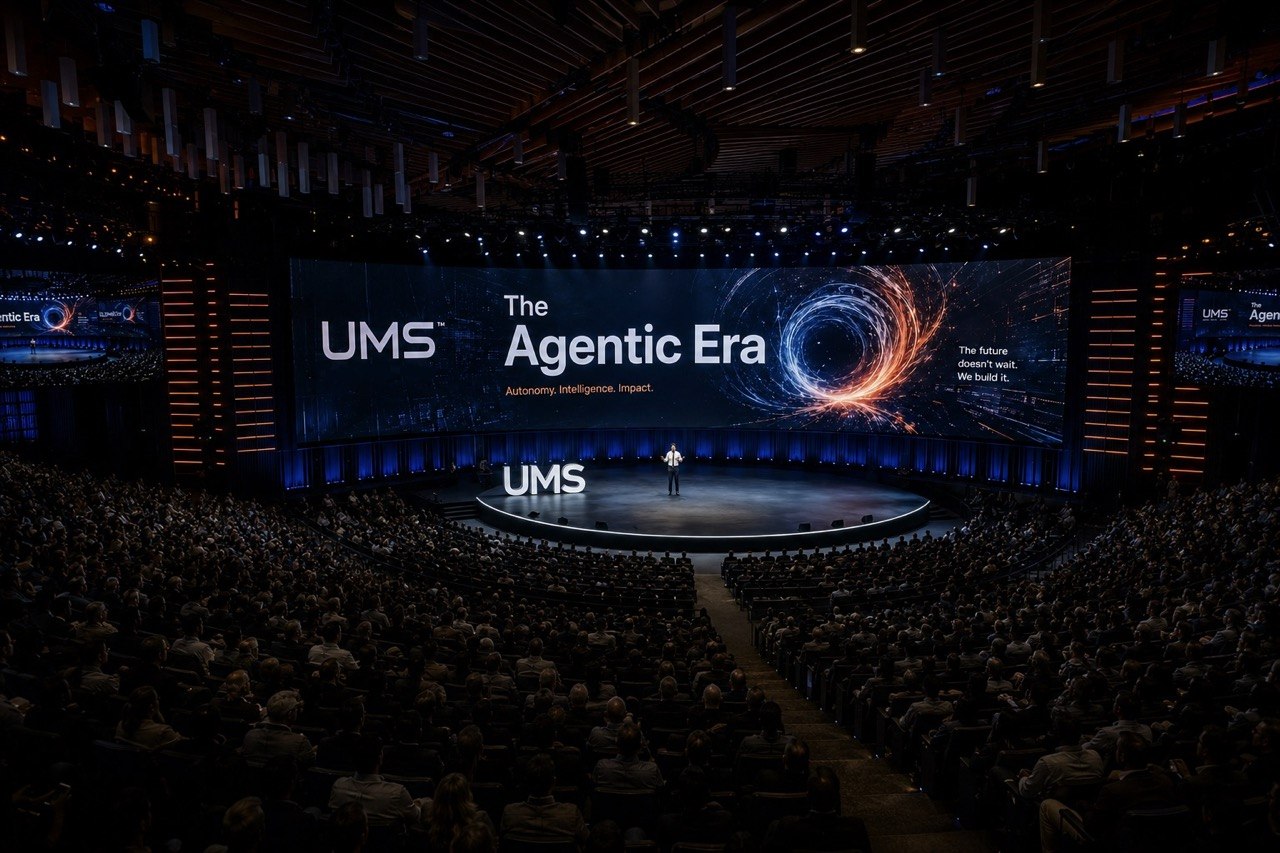 Agentic era conference stage with UMS branding